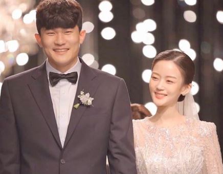 Kim Min-jae with his wife on their wedding day